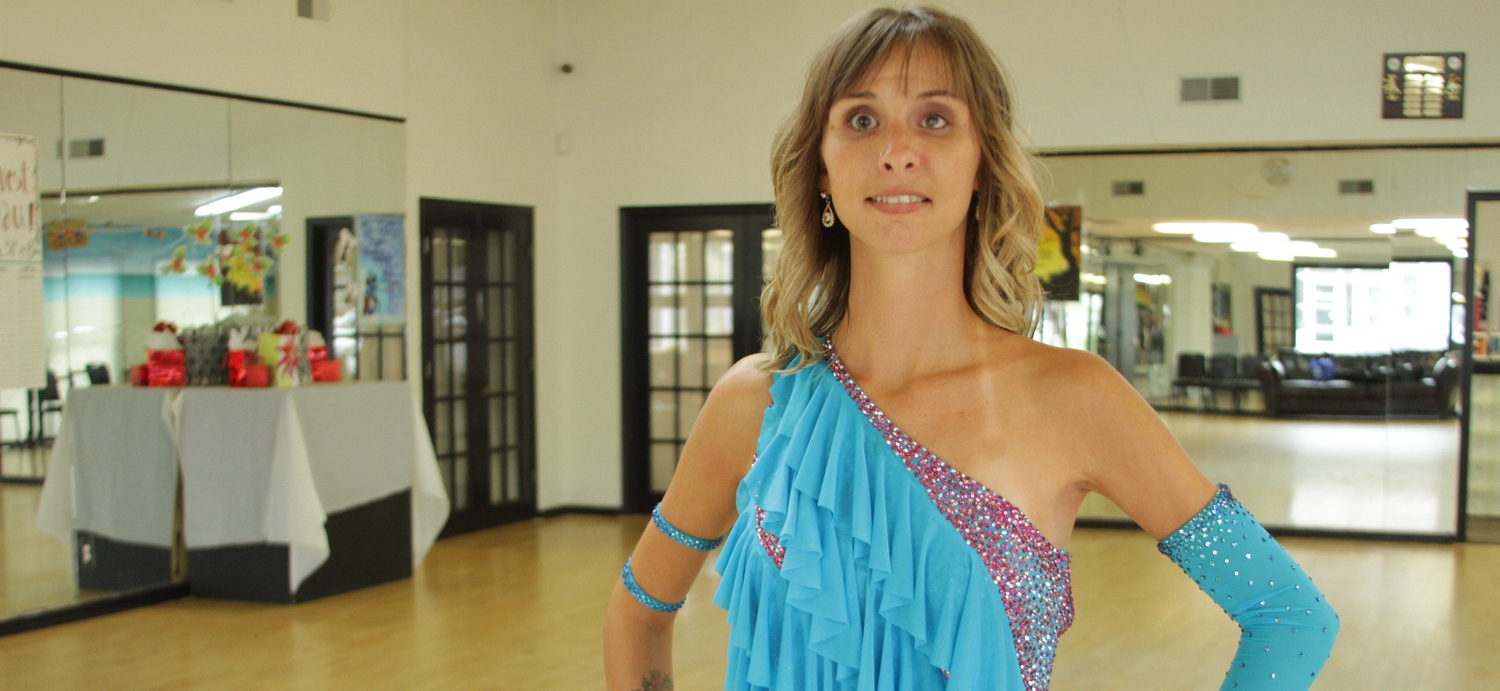 Stephanie Bollinger wearing blue dance attire while in a dance studio.